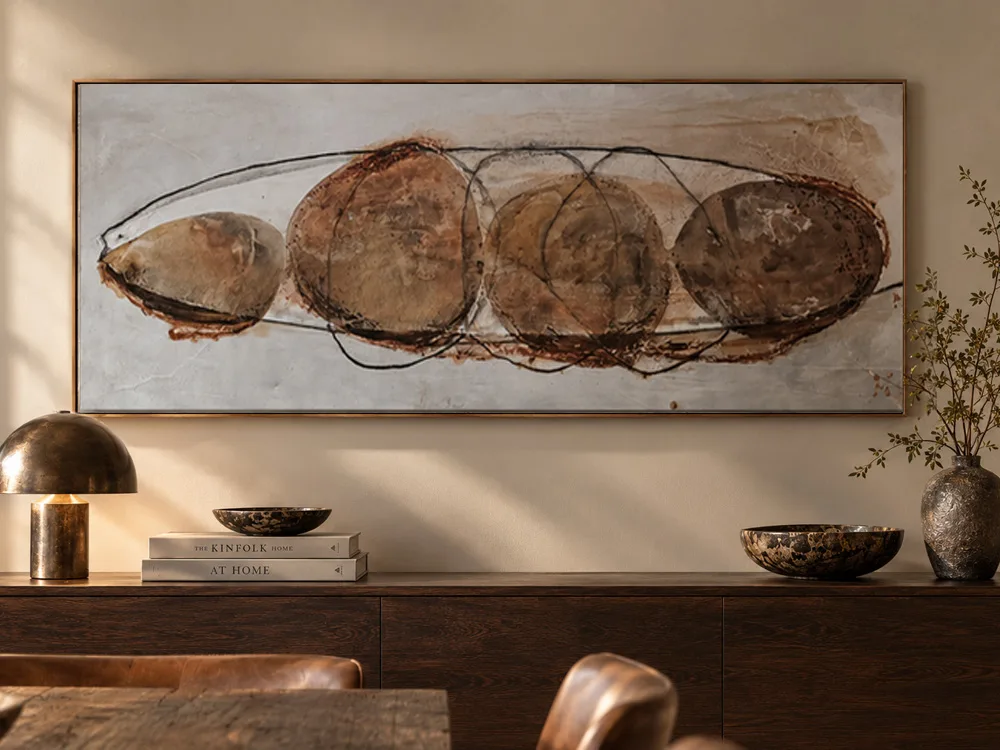 Glutton by Conchita Carambano, rust and umber abstract painting hung above a dining sideboard